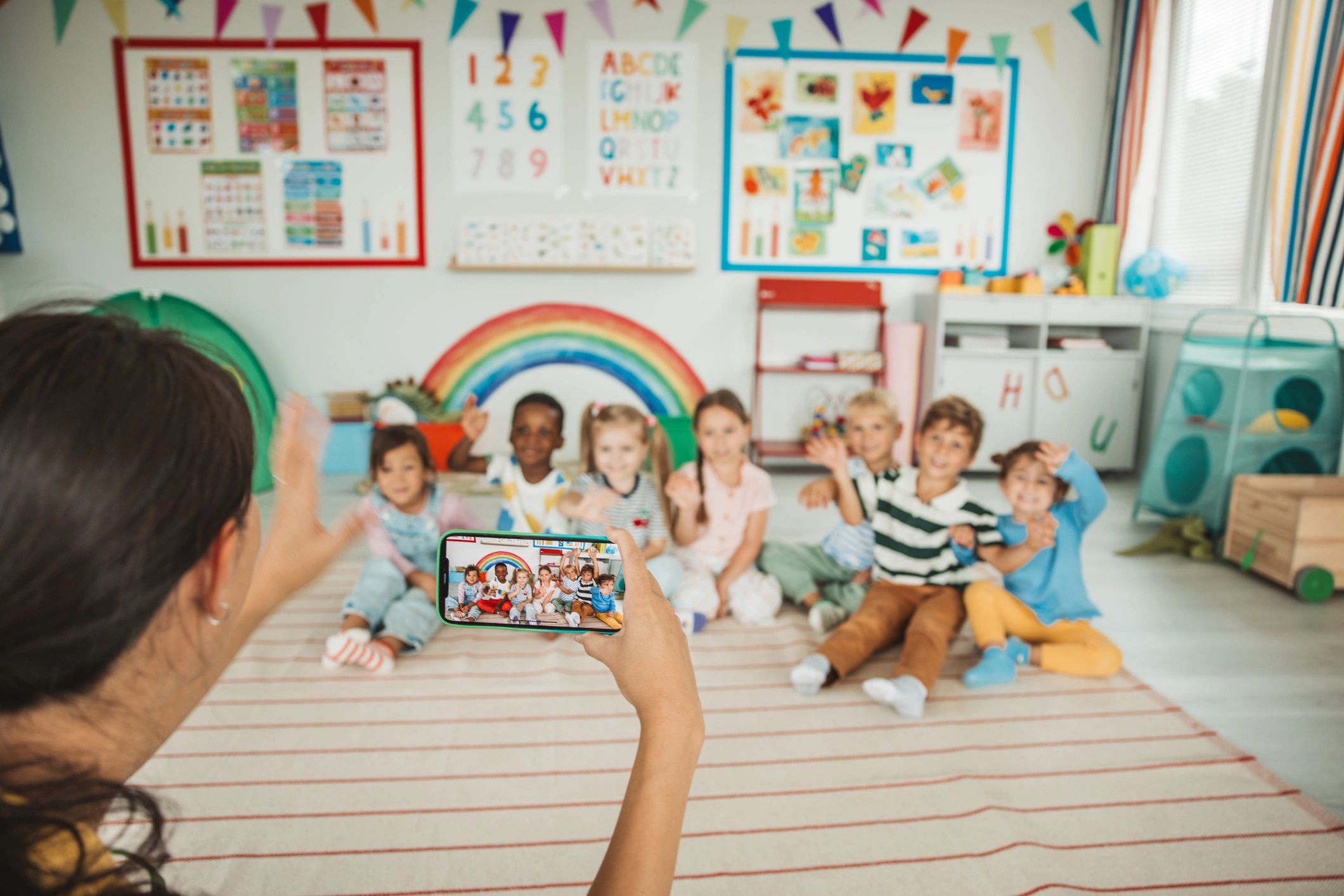 Teacher engaging preschool students during a school activity